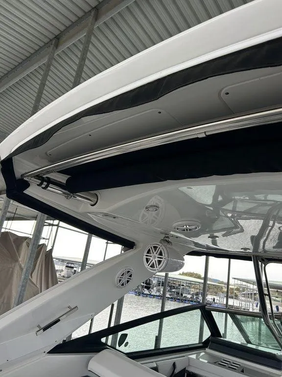 Slide: The Image of 2023 Monterey 378SS boat interior under a covered dock, showcasing sleek design and modern features. - 49