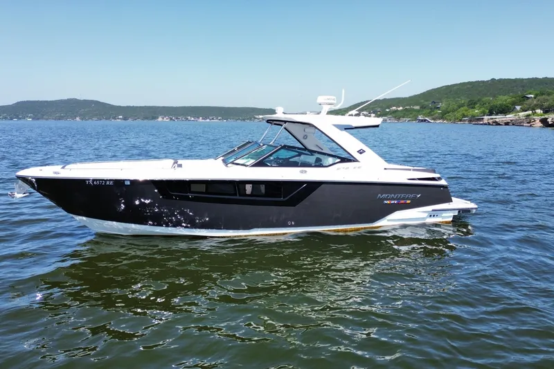 The Image of 2023 Monterey 378SS Super Sport boat on a scenic lake with hills in the background. - 0