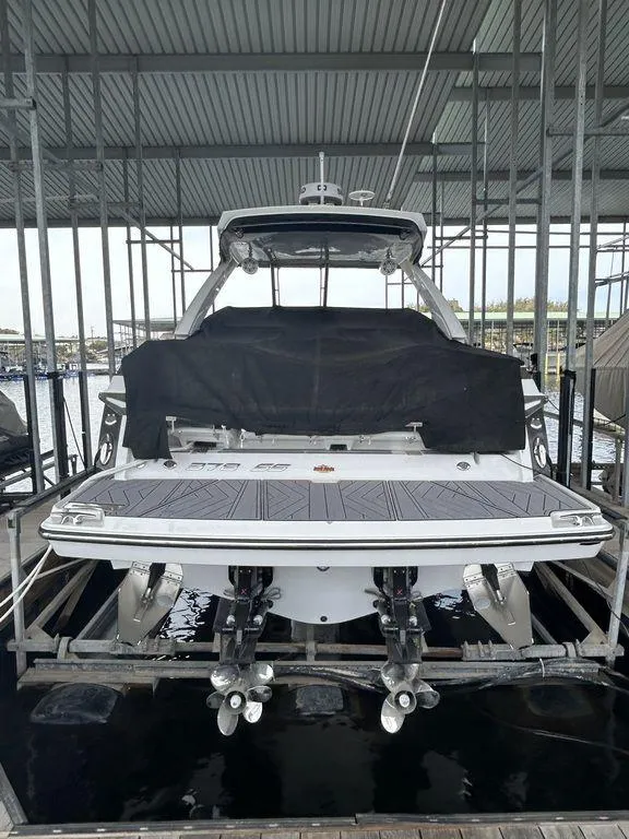 Slide: The Image of 2023 Monterey 378SS Super Sport boat on a serene lake with scenic background. - 2