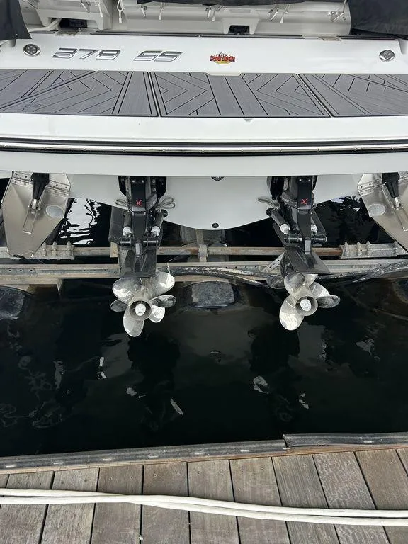 Slide: The Image of 2023 Monterey 378SS Super Sport boat on a serene lake with scenic background. - 5