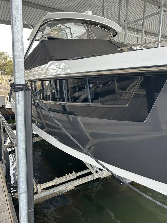 Slide: The Image of 2023 Monterey 378SS Super Sport boat on a serene lake with scenic background. - 6