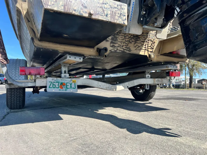 Slide: The Image of 2012 SeaArk 1872 boat on trailer, rear view, with visible license plate and tires. - 10