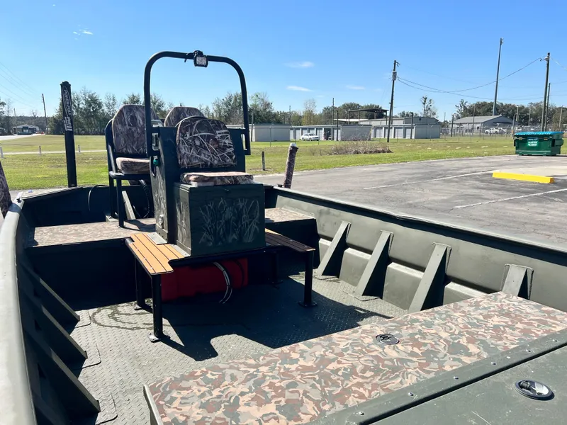 Slide: The Image of 2012 SeaArk 1872 boat interior with camo seats and open deck. - 19