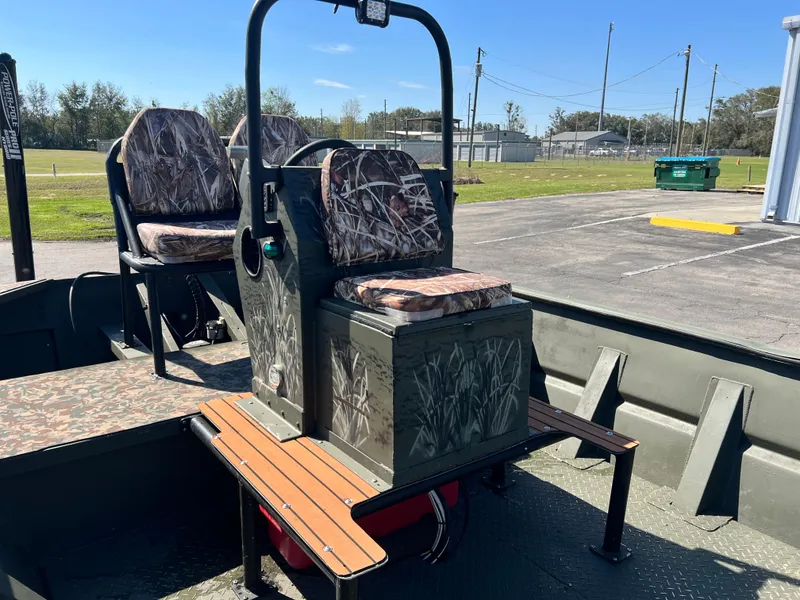 Slide: The Image of 2012 SeaArk 1872 boat interior with camo seats and steering console. - 20