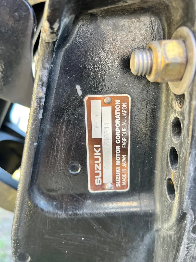 Slide: The Image of Close-up of a Suzuki motor label on a 2012 SeaArk 1872 boat. - 23