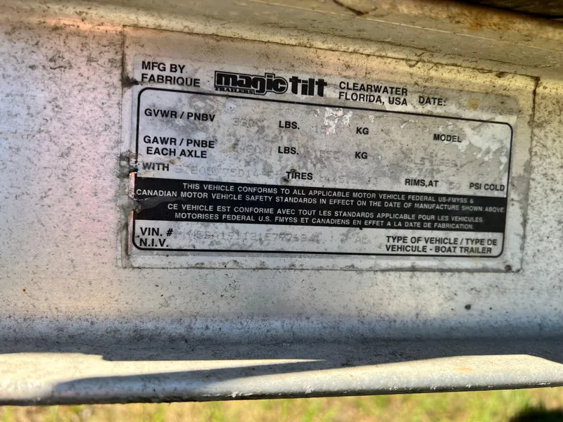 Slide: The Image of Label on Magic Tilt boat trailer, Clearwater, Florida, showing weight specifications and VIN details. - 25