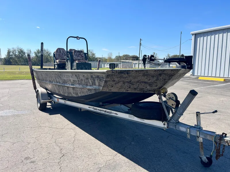 Slide: The Image of 2012 SeaArk 1872 boat on trailer in parking lot, clear sky background. - 3