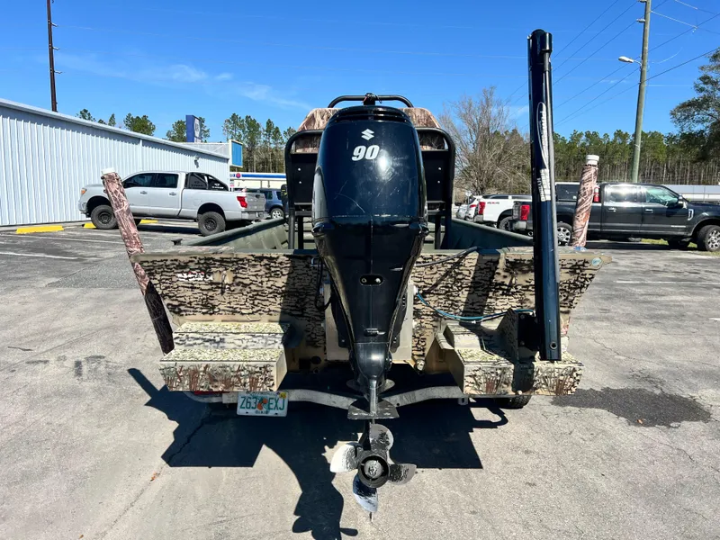 Slide: The Image of 2012 SeaArk 1872 boat with Suzuki 90 outboard motor, parked outdoors. - 9
