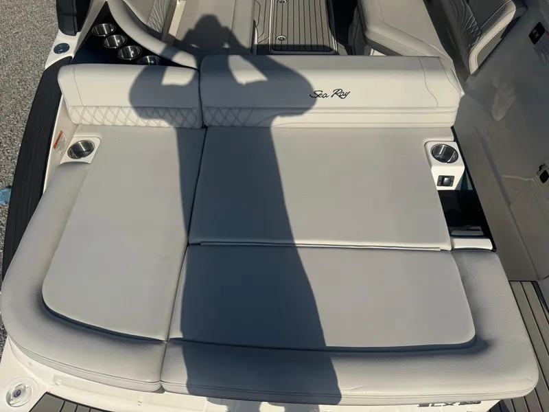 Slide: The Image of 2025 Sea Ray SLX 260 boat seating area with cup holders and luxury upholstery. - 12