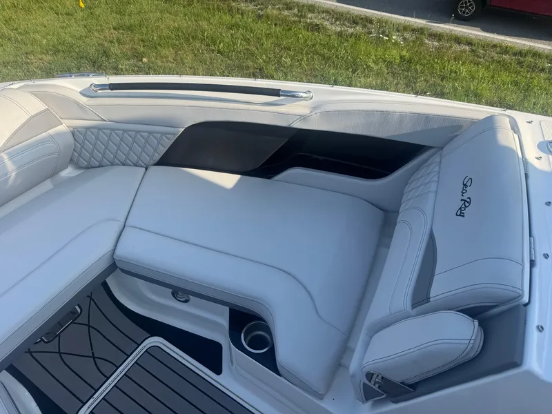 Slide: The Image of 2025 Sea Ray SLX 260 boat interior with luxurious white seating and elegant design. - 15