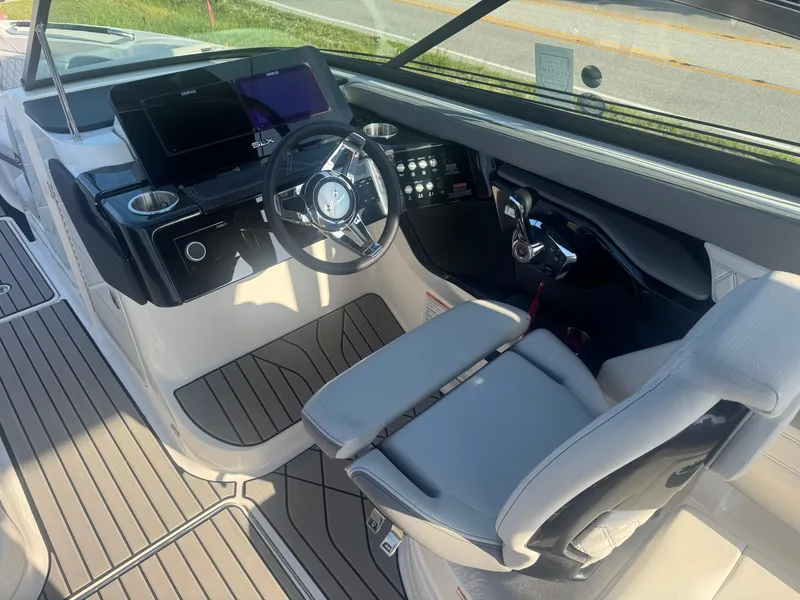 Slide: The Image of 2025 Sea Ray SLX 260 boat cockpit with modern controls and sleek design. - 18