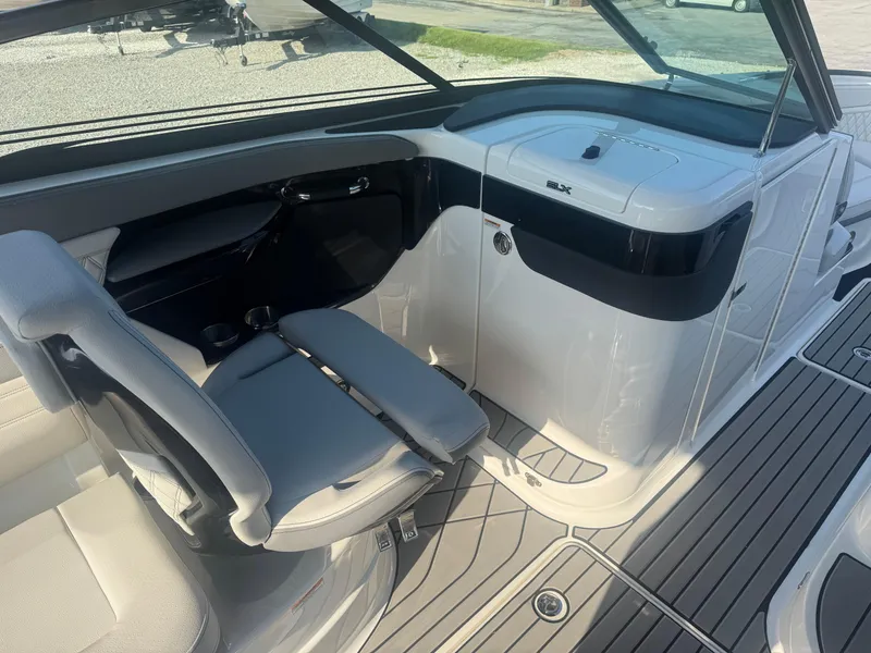 Slide: The Image of 2025 Sea Ray SLX 260 boat interior with sleek seating and modern dashboard design. - 19