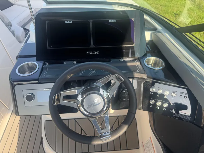 Slide: The Image of 2025 Sea Ray SLX 260 helm with modern controls and dual Simrad displays. - 20