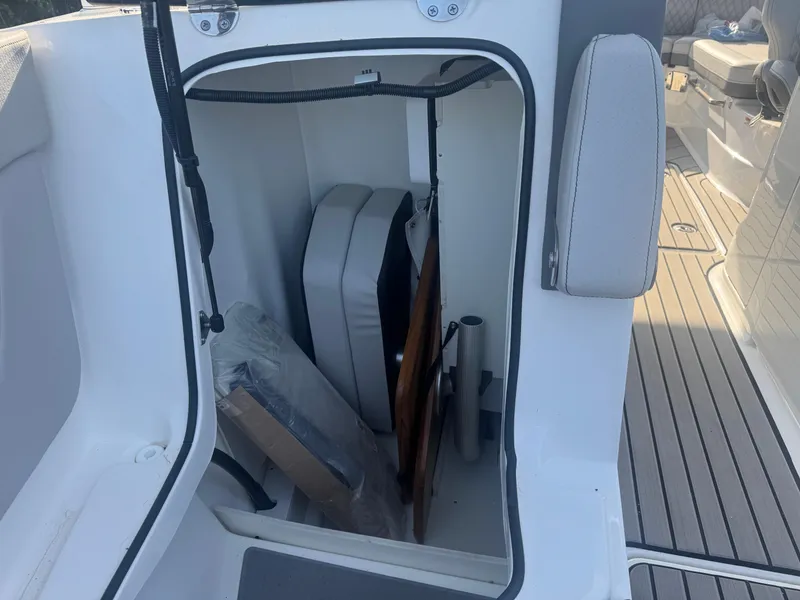 Slide: The Image of Storage compartment on a 2025 Sea Ray SLX 260 boat, showing interior details. - 22