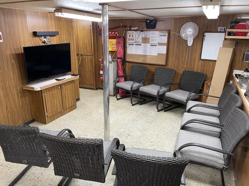 Slide: The Image of Crew lounge on 2002 custom offshore supply vessel with chairs, TV, and safety equipment. - 10