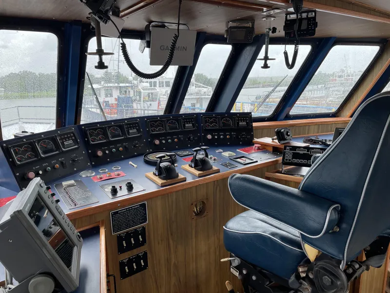 Slide: The Image of Control room of a 2002 Custom Offshore Supply Vessel with navigation equipment and captain's chair. - 11