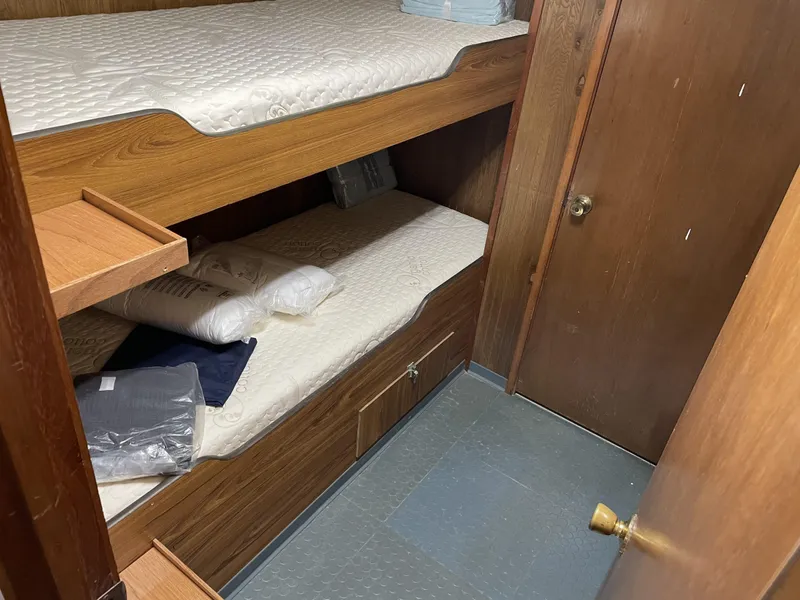 Slide: The Image of Bunk beds in a 2002 custom offshore supply vessel cabin, featuring wooden interiors and bedding. - 16