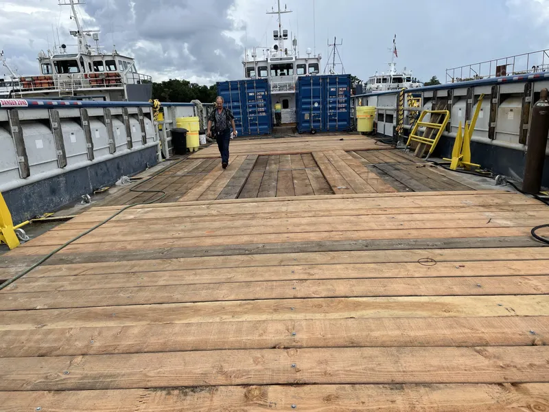 Slide: The Image of Wooden deck of a 2002 custom offshore supply vessel with containers and equipment. - 4