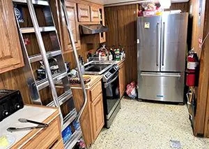 Slide: The Image of Galley kitchen on a 2002 custom offshore supply vessel with wooden cabinets and stainless steel appliances. - 7