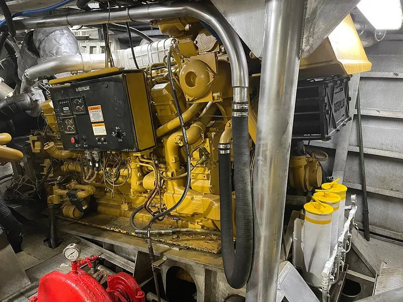 Slide: The Image of Engine room of a 2002 custom offshore supply vessel, featuring machinery and control panels. - 8