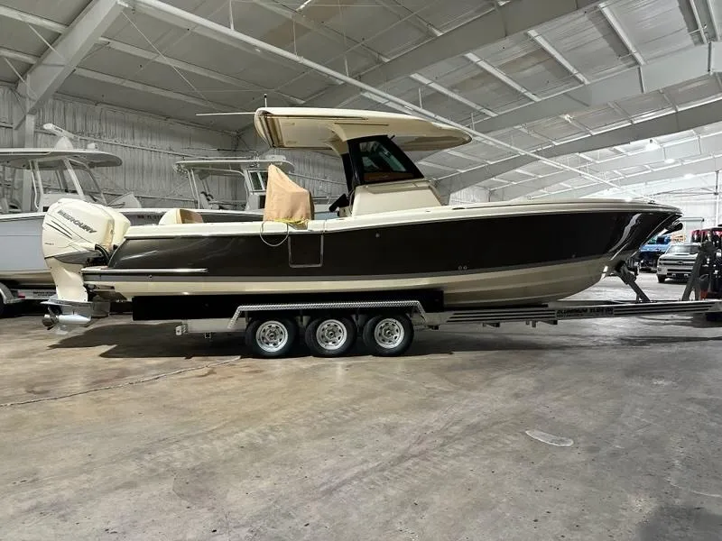 Slide: The Image of 2022 Chris-Craft Catalina 30 boat on trailer in indoor storage facility. - 0