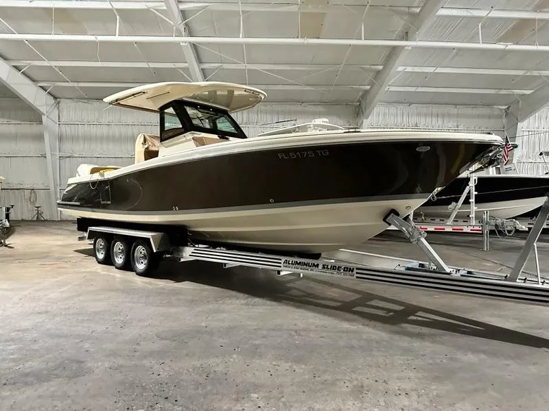 Slide: The Image of 2022 Chris-Craft Catalina 30 boat on trailer in indoor storage facility. - 1