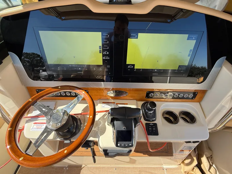 Slide: The Image of 2022 Chris-Craft Catalina 30 dashboard with dual screens and wooden steering wheel. - 10