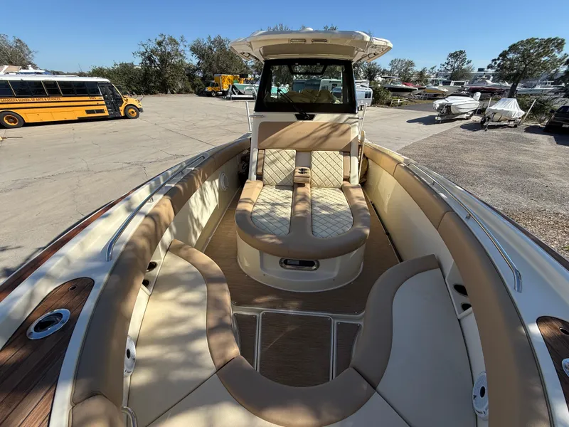 Slide: The Image of 2022 Chris-Craft Catalina 30 boat with tan seating, docked outdoors. - 15