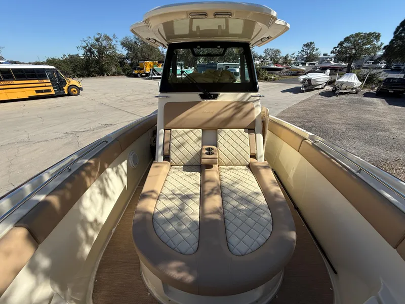 Slide: The Image of 2022 Chris-Craft Catalina 30 boat interior with beige seating and helm station. - 16