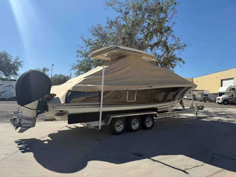 Slide: The Image of 2022 Chris-Craft Catalina 30 boat on trailer, covered, parked outdoors. - 18