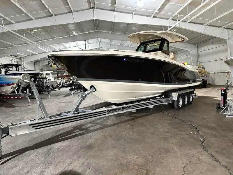 Slide: The Image of 2022 Chris-Craft Catalina 30 boat on trailer in indoor storage facility. - 2