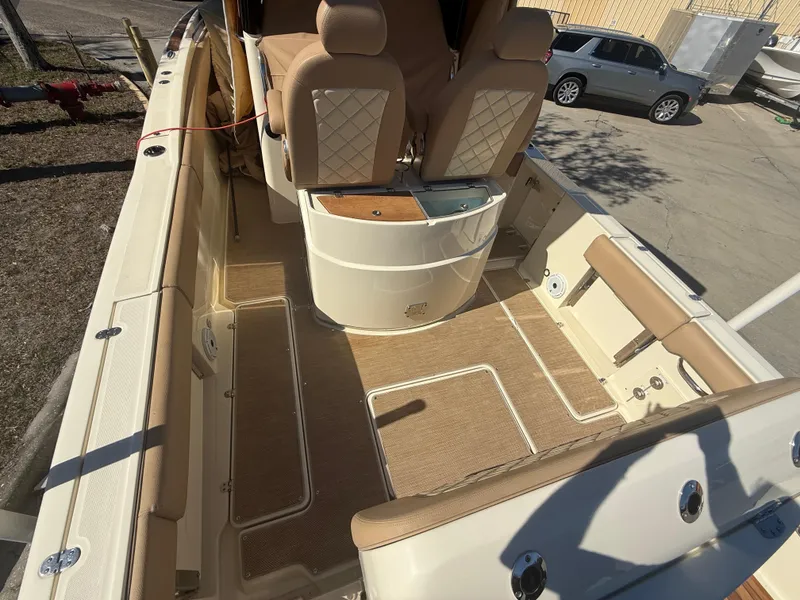 Slide: The Image of 2022 Chris-Craft Catalina 30 interior with beige seating and deck, showcasing luxury design. - 4