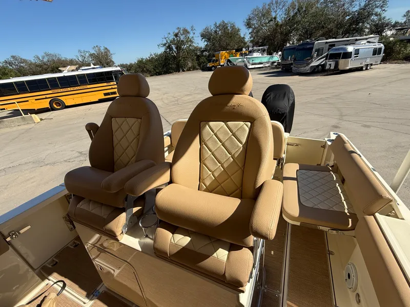 Slide: The Image of Luxurious seating on 2022 Chris-Craft Catalina 30 boat, featuring tan upholstery and diamond stitching. - 9