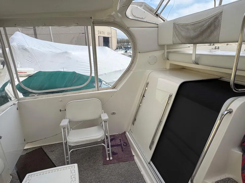 Slide: The Image of 2003 Silverton 39 Motor Yacht interior with seating and covered windows. - 10