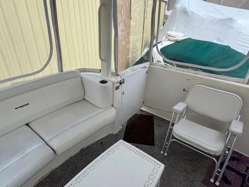 Slide: The Image of Interior of 2003 Silverton 39 Motor Yacht with white seating and table. - 11