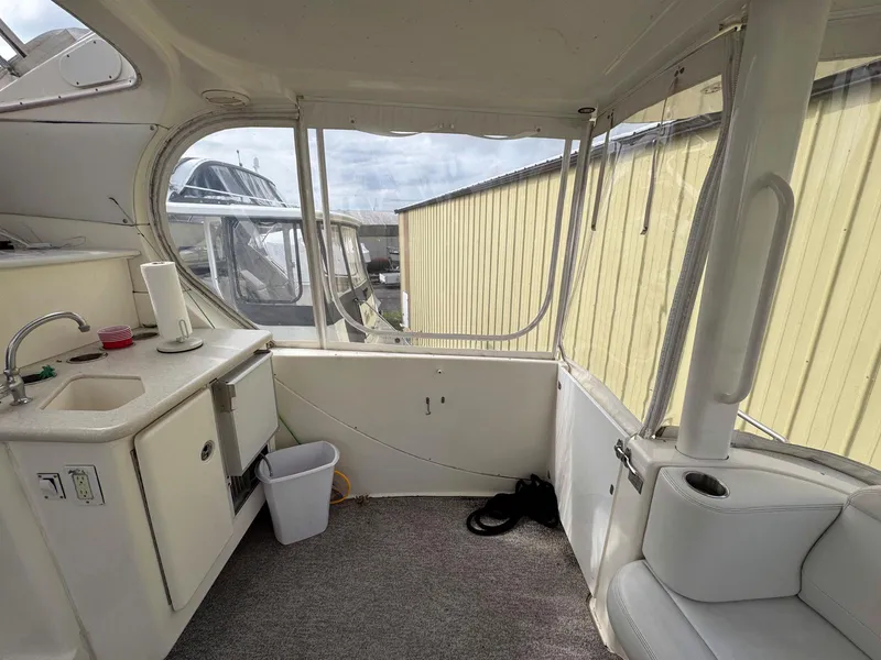 Slide: The Image of 2003 Silverton 39 Motor Yacht interior with kitchenette and seating area. - 13