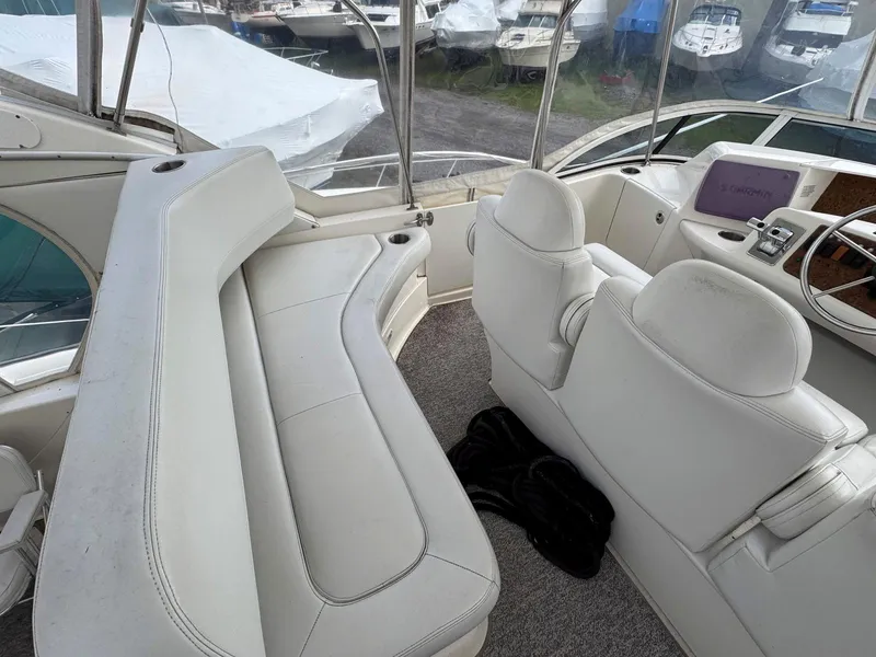 Slide: The Image of 2003 Silverton 39 Motor Yacht interior with white seating and helm station. - 14