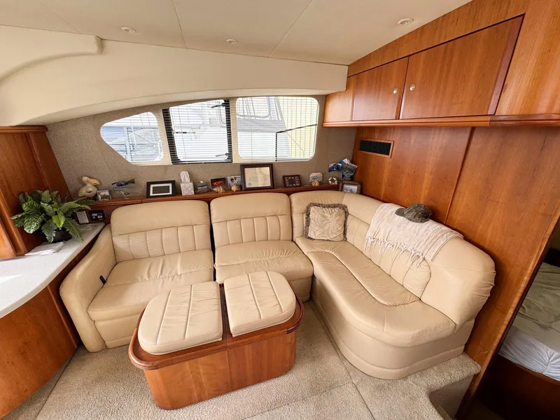 Slide: The Image of Luxurious interior of 2003 Silverton 39 Motor Yacht with beige leather seating and wooden cabinetry. - 18