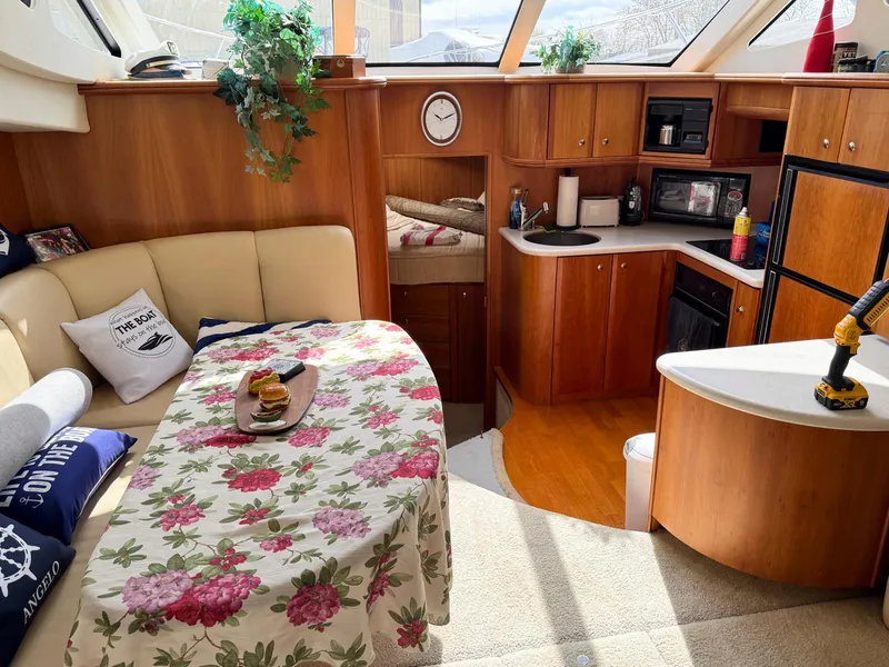 Slide: The Image of Interior of 2003 Silverton 39 Motor Yacht with cozy seating and kitchen area. - 19