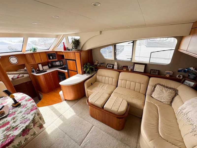 Slide: The Image of Luxurious 2003 Silverton 39 Motor Yacht interior with plush seating and modern kitchen amenities. - 24