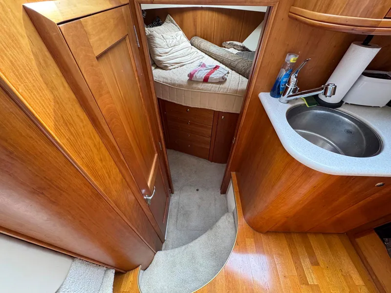 Slide: The Image of 2003 Silverton 39 Motor Yacht interior with cozy cabin and compact kitchenette. - 26