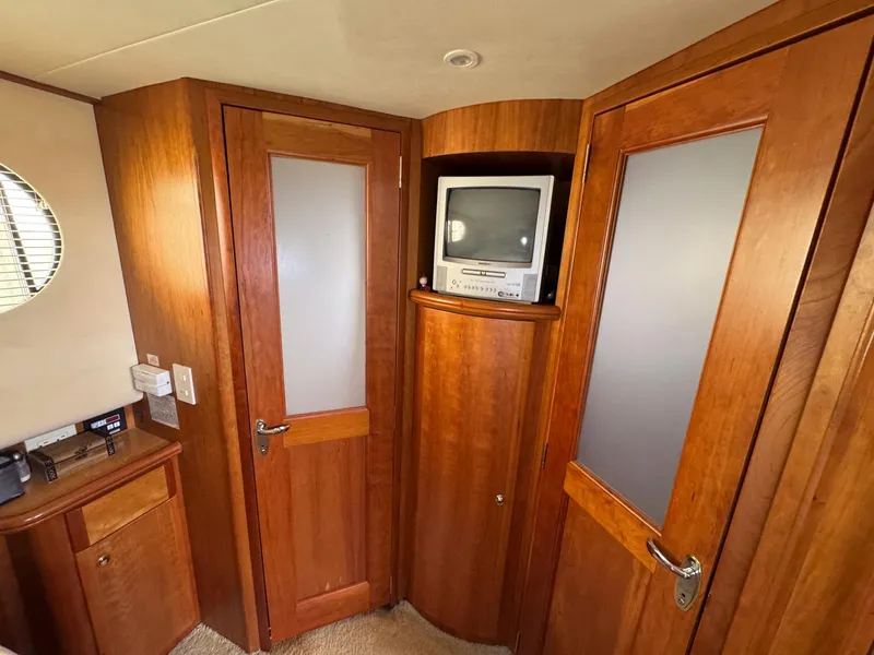 Slide: The Image of 2003 Silverton 39 Motor Yacht interior with wood paneling and built-in TV. - 32