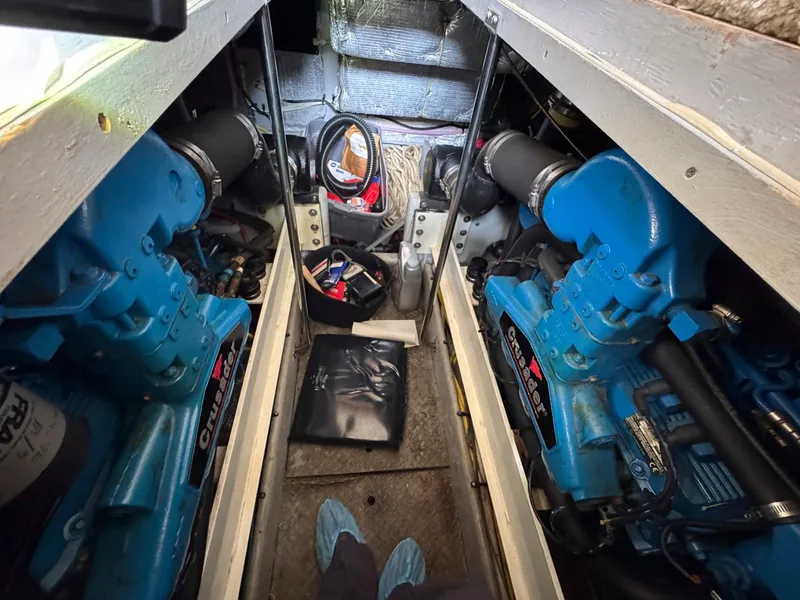 Slide: The Image of Engine room of a 2003 Silverton 39 Motor Yacht with twin blue engines. - 34