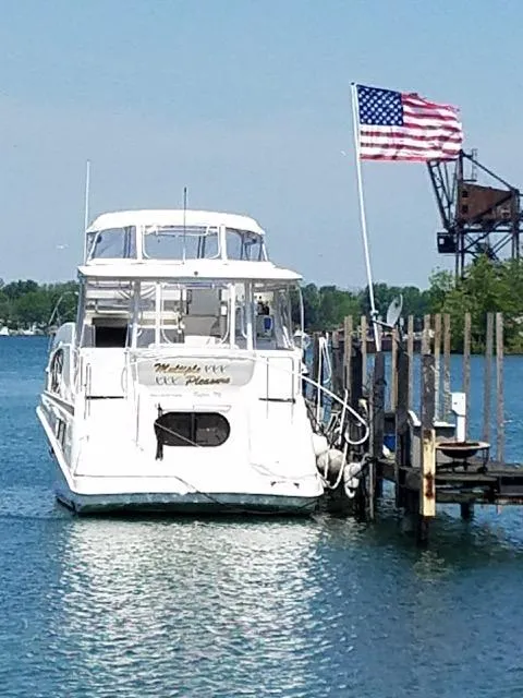 Slide: The Image of 2003 Silverton 39 Motor Yacht docked with American flag in background. - 5