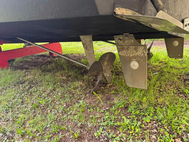 Slide: The Image of Propeller and rudder of a 2003 Silverton 39 Motor Yacht on grass. - 9