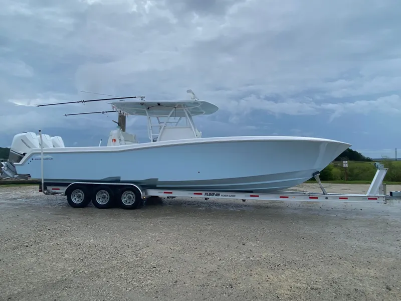 The Image of 2021 Invincible 36 Open Fisherman boat on trailer under cloudy sky. - 0