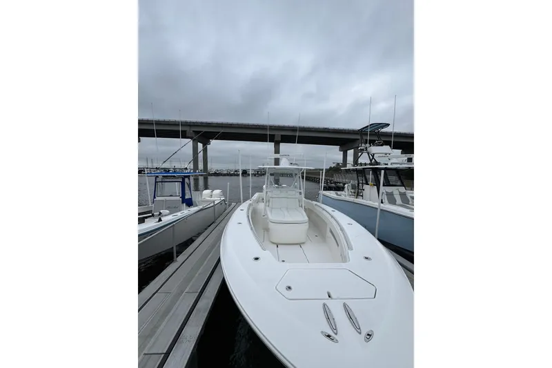 Slide: The Image of Invincible 36 Open Fisherman 2021 at dock under gray sky. - 11