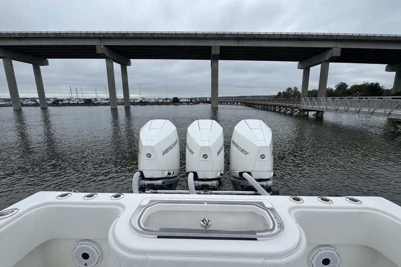 Slide: The Image of 2021 Invincible 36 Open Fisherman with triple Mercury engines under a bridge. - 12