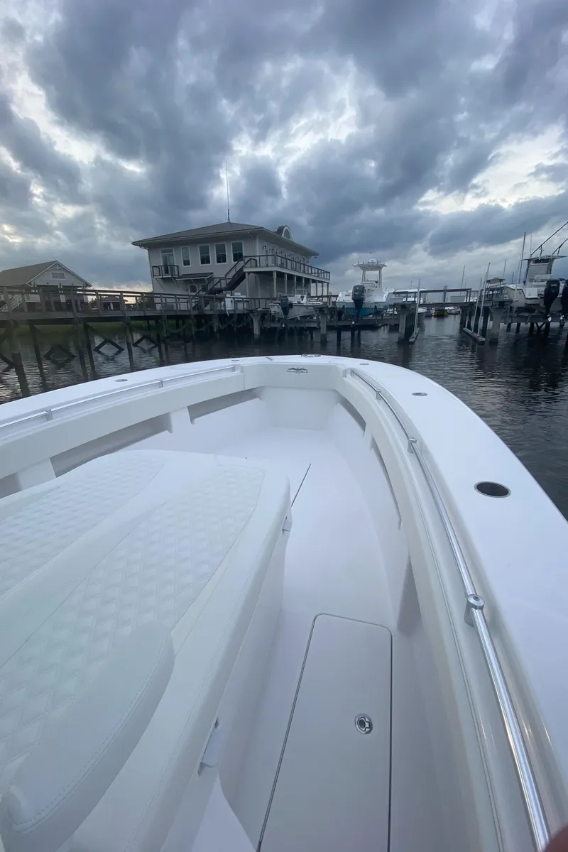 Slide: The Image of 2021 Invincible 36 Open Fisherman boat docked under cloudy skies. - 5
