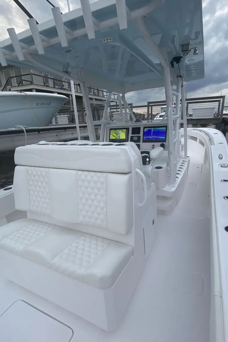 Slide: The Image of 2021 Invincible 36 Open Fisherman boat with white seating and advanced navigation displays. - 7